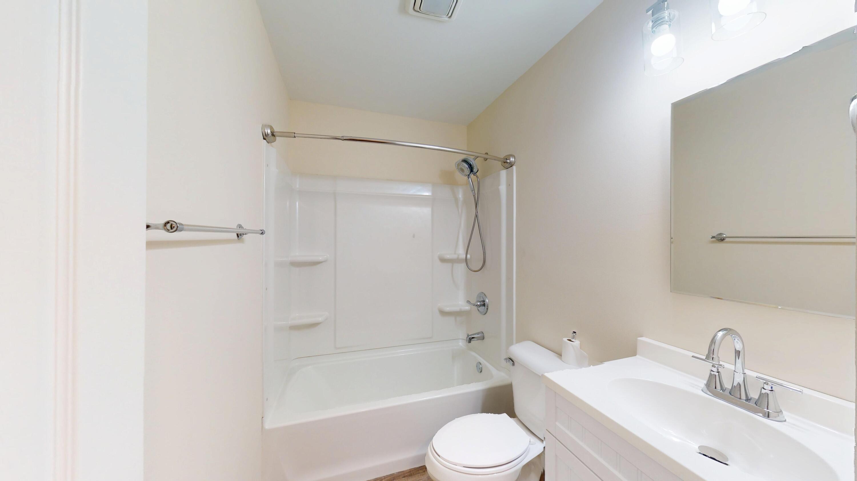 317 Redpath Avenue Michigan City, IN 46360 - Photo 17 of 40 a bathroom with a bathtub shower sink vanity mirror and toilet