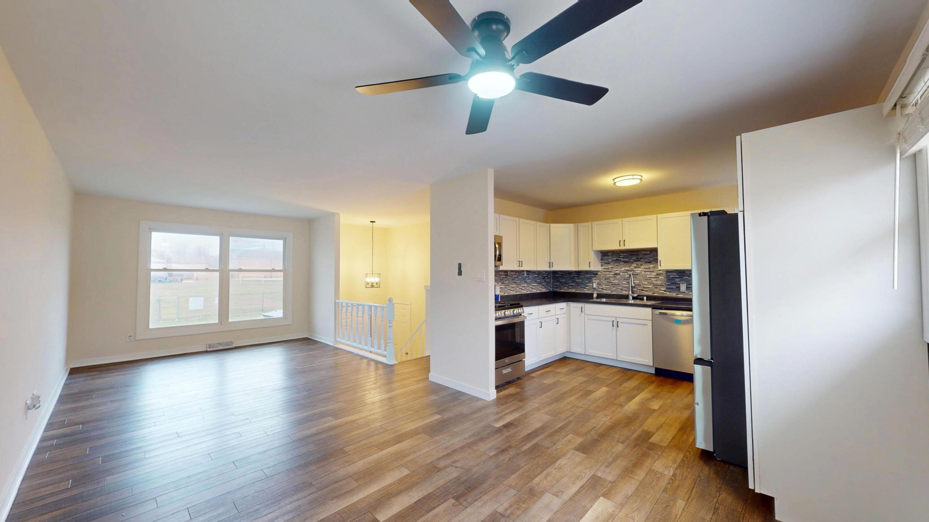 317 Redpath Avenue Michigan City, IN 46360 - Photo 4 of 40 a large kitchen with cabinets wooden floor and stainless steel appliances