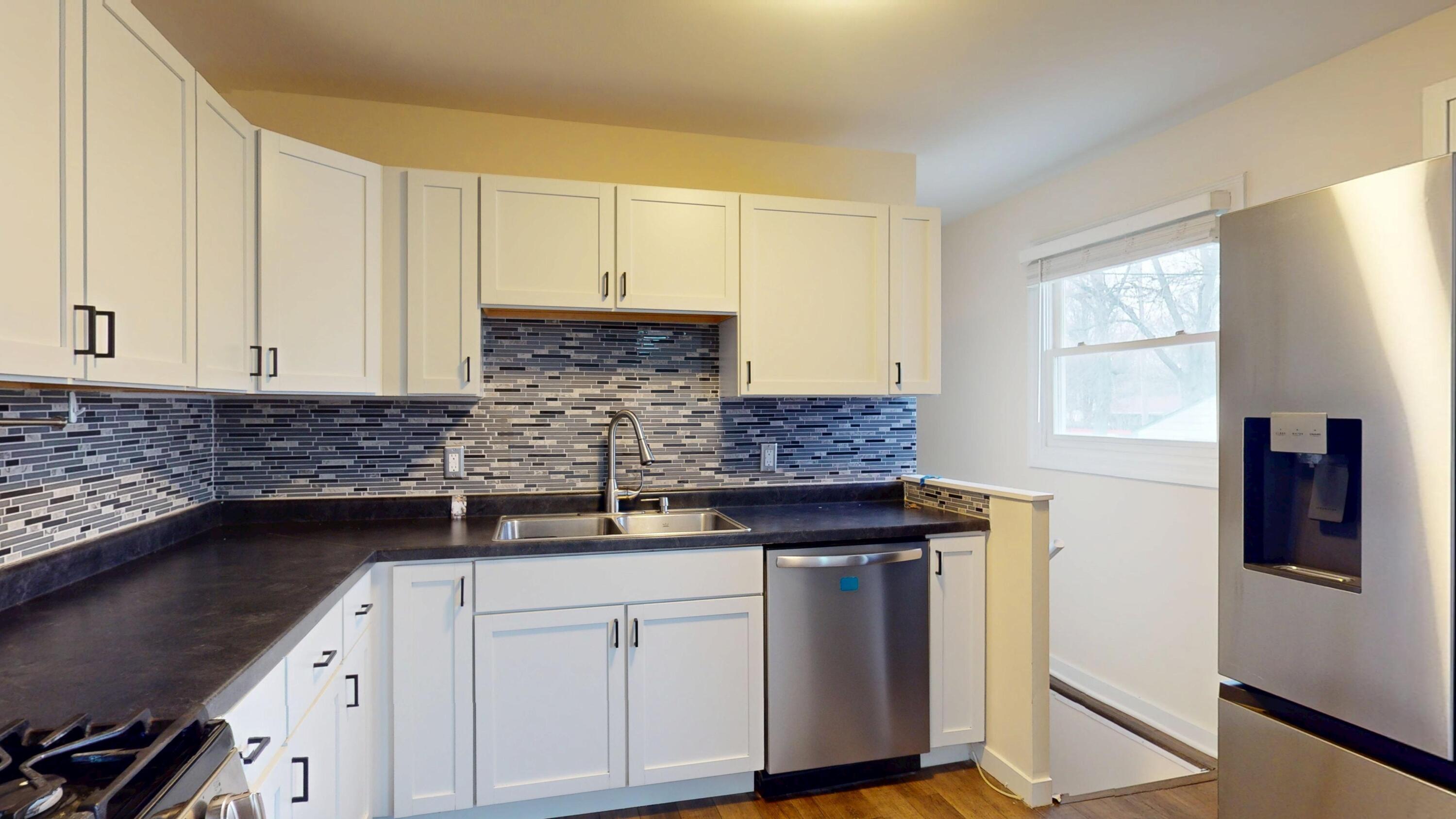 317 Redpath Avenue Michigan City, IN 46360 - Photo 6 of 40 a kitchen with a sink and cabinets
