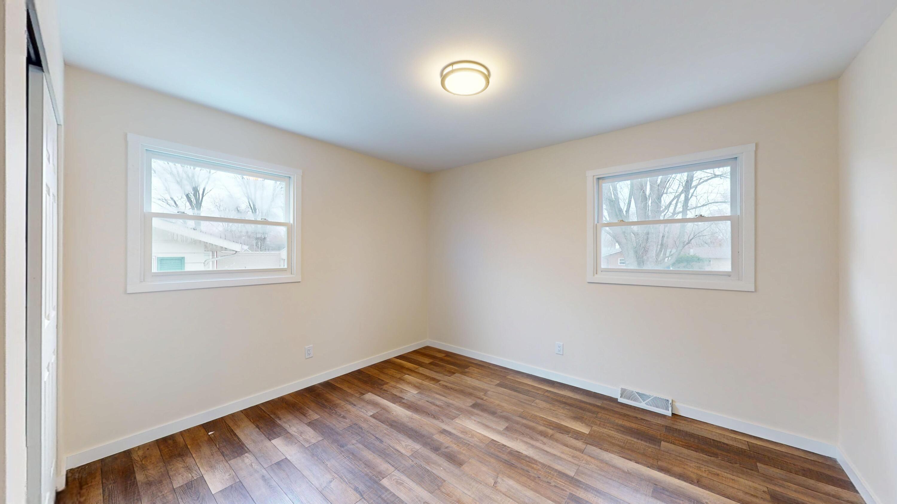 317 Redpath Avenue Michigan City, IN 46360 - Photo 8 of 40 a view of empty room with wooden floor and fan