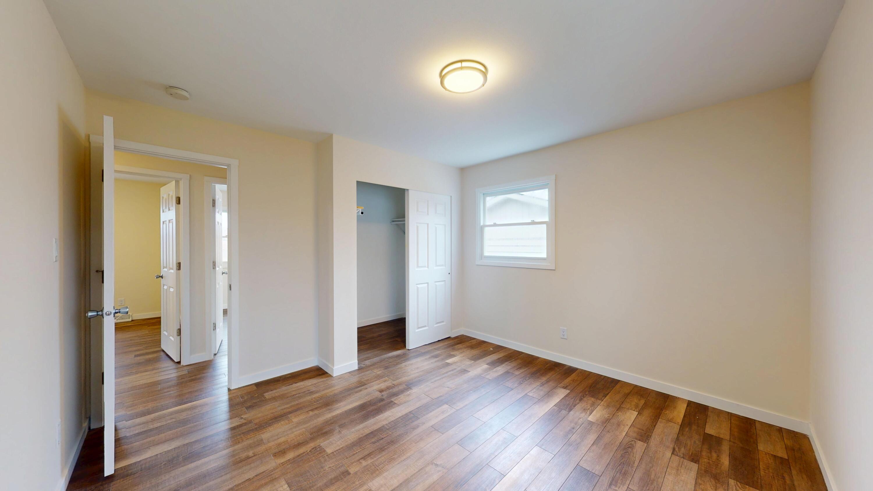 317 Redpath Avenue Michigan City, IN 46360 - Photo 9 of 40 wooden floor in an empty room with a window