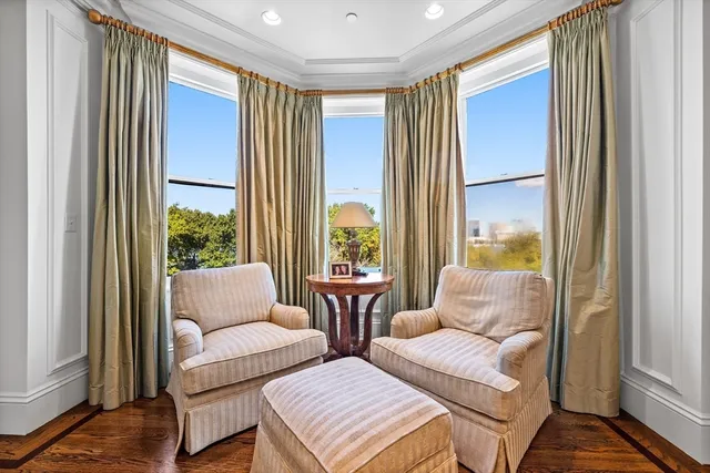 a living room with fireplace furniture and a wooden floor
