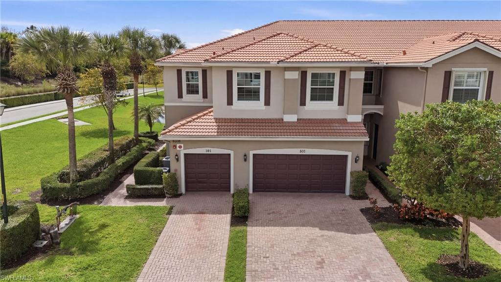 6525 Monterey Point, Unit 101 Naples, FL 34105 - Photo 1 of 18 End unit carriage home with attached garage and private side entry..