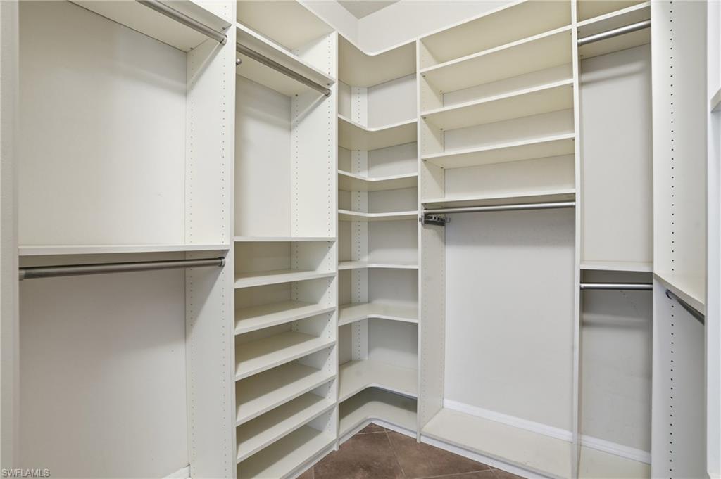 6525 Monterey Point, Unit 101 Naples, FL 34105 - Photo 12 of 18 Nicely appointed primary suite closet.