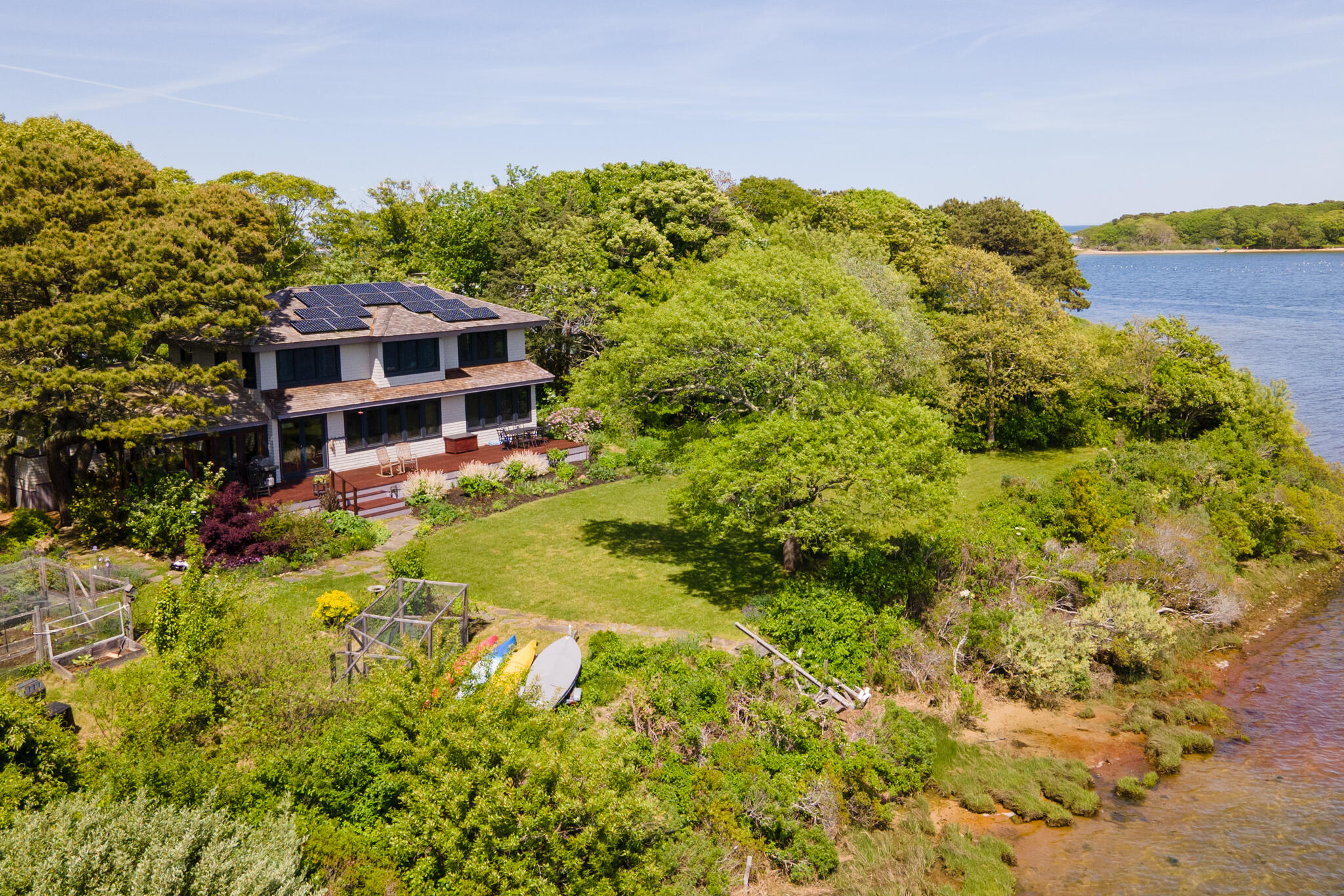 a view of a big house with a big yard and large trees