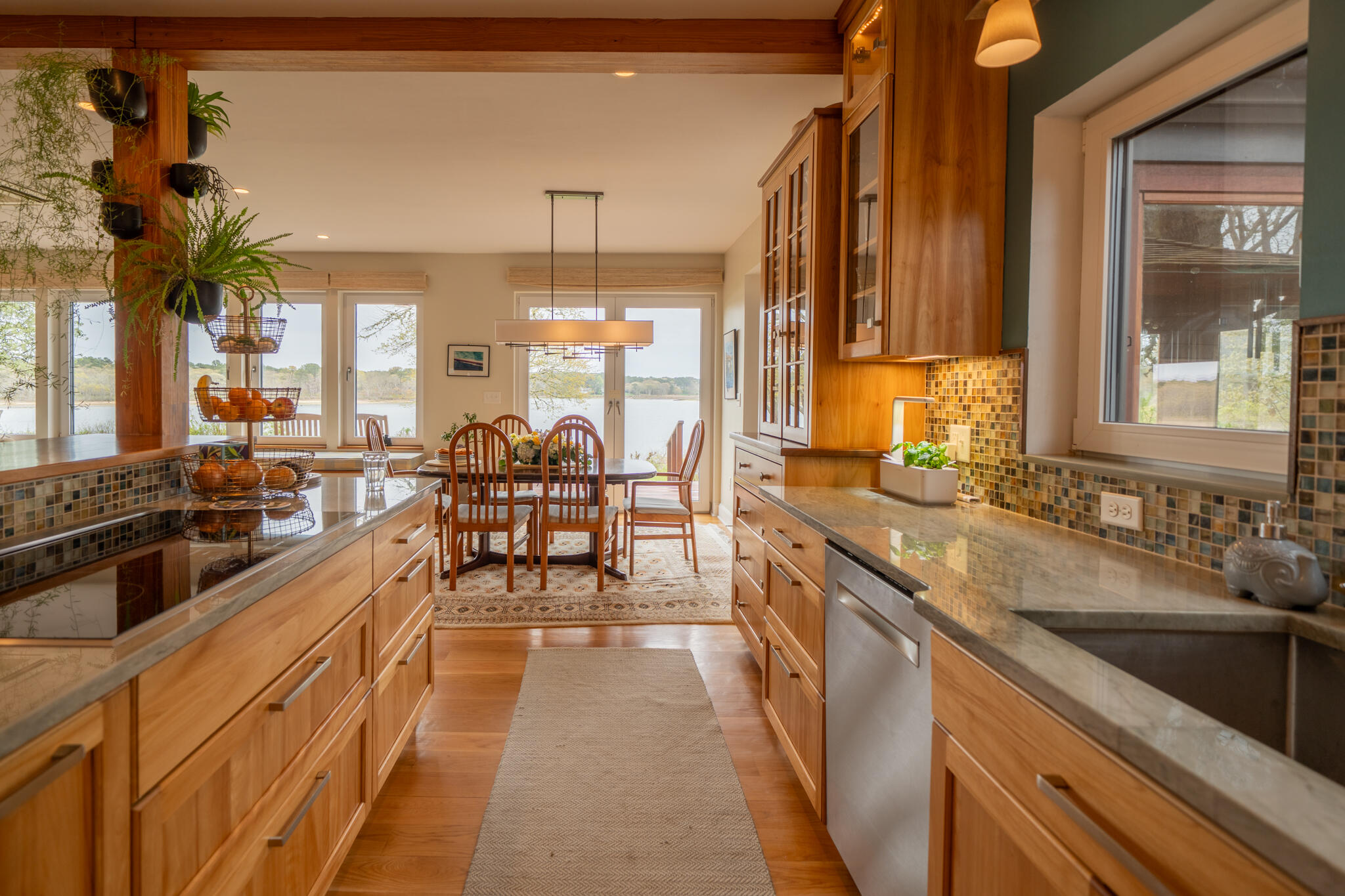 39 Sengekontacket Road Oak Bluffs, MA 02557 - Photo 11 of 32 a large kitchen with kitchen island granite countertop a large window and stainless steel appliances