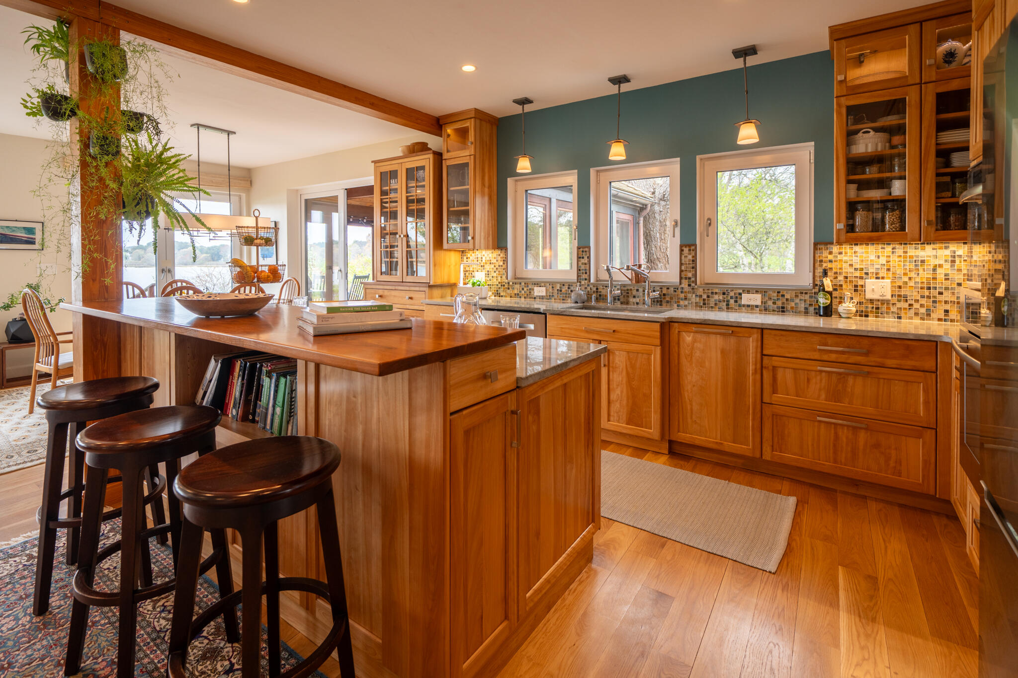 39 Sengekontacket Road Oak Bluffs, MA 02557 - Photo 12 of 32 a kitchen with stainless steel appliances granite countertop a table chairs stove and wooden floor
