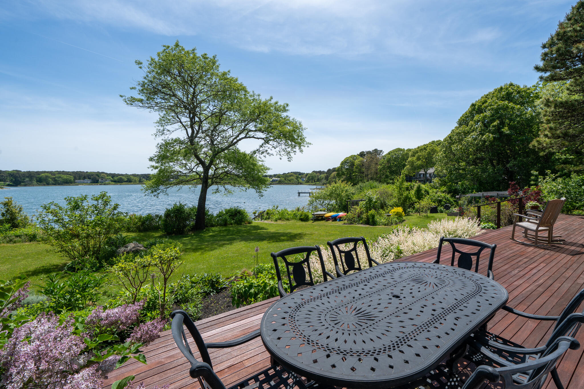 39 Sengekontacket Road Oak Bluffs, MA 02557 - Photo 29 of 32 a view of a chairs and table in patio with lake view