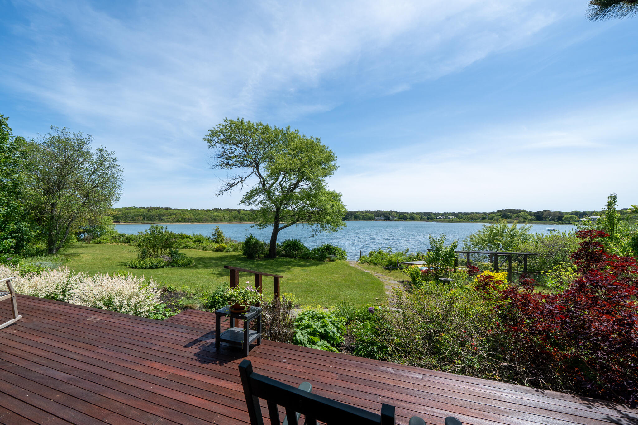 39 Sengekontacket Road Oak Bluffs, MA 02557 - Photo 30 of 32 a view of a lake with a floor to ceiling window next to a yard