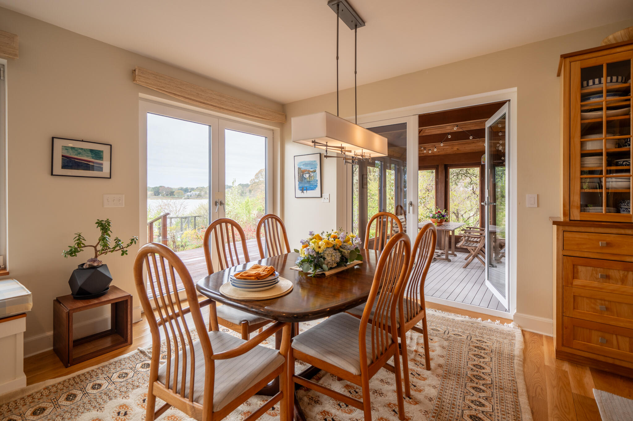 39 Sengekontacket Road Oak Bluffs, MA 02557 - Photo 10 of 32 a dining room with furniture a chandelier and wooden floor