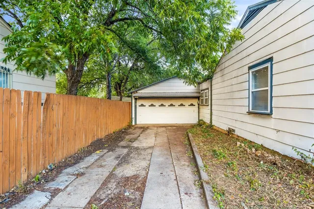 a front view of a house with a yard and a garage
