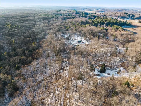 an aerial view of house with yard and mountain view in back