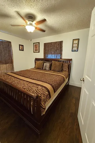 a large bed sitting in a bedroom next to a lamp