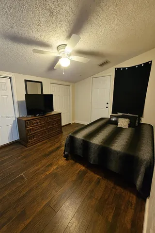 a bedroom with a bed and flat screen tv