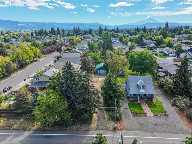 an aerial view of a house with a yard and lake view