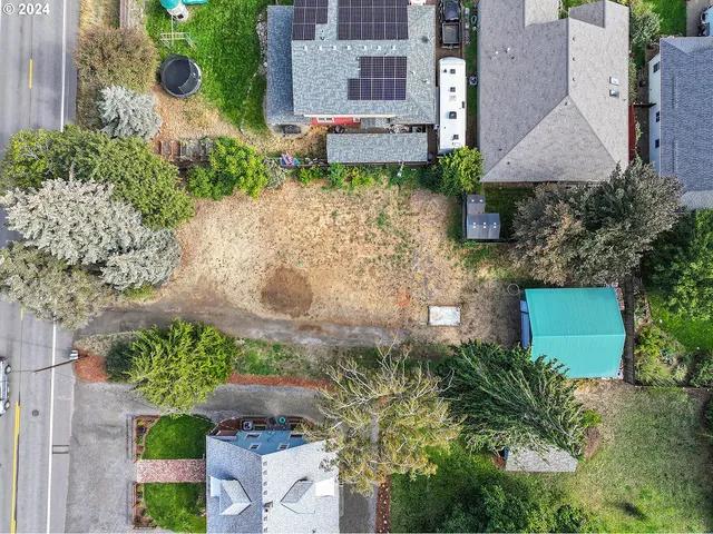 a aerial view of a house with a yard and garden