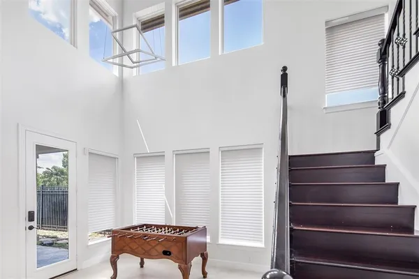 a view of a patio with couches and table with wooden floor and fence