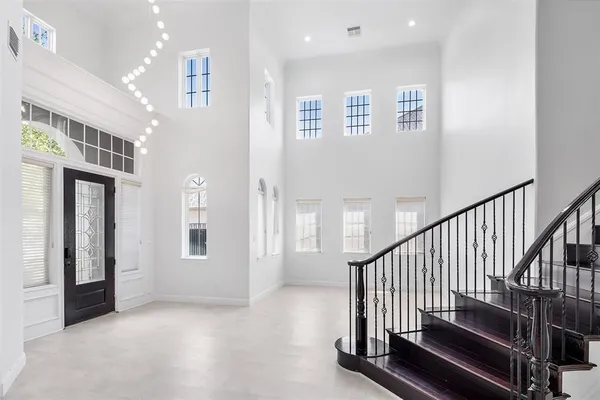 a view of staircase with lots of white walls and a window
