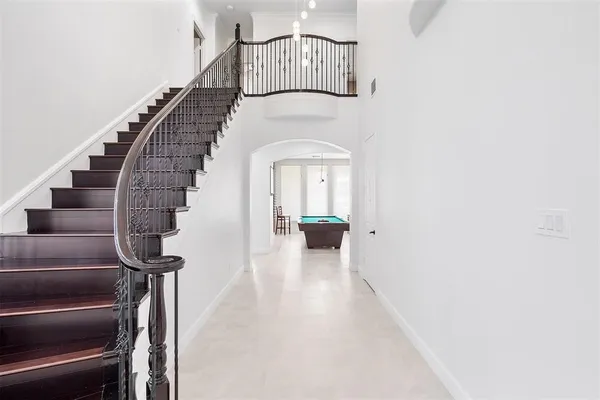 a room with pool table and windows
