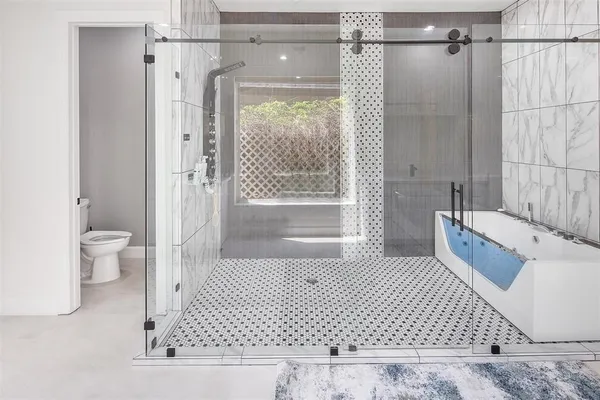 a bathroom with a bathtub sink and vanity