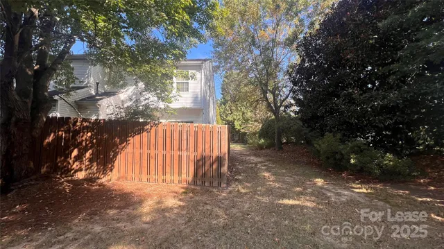 a view of backyard of house with green space