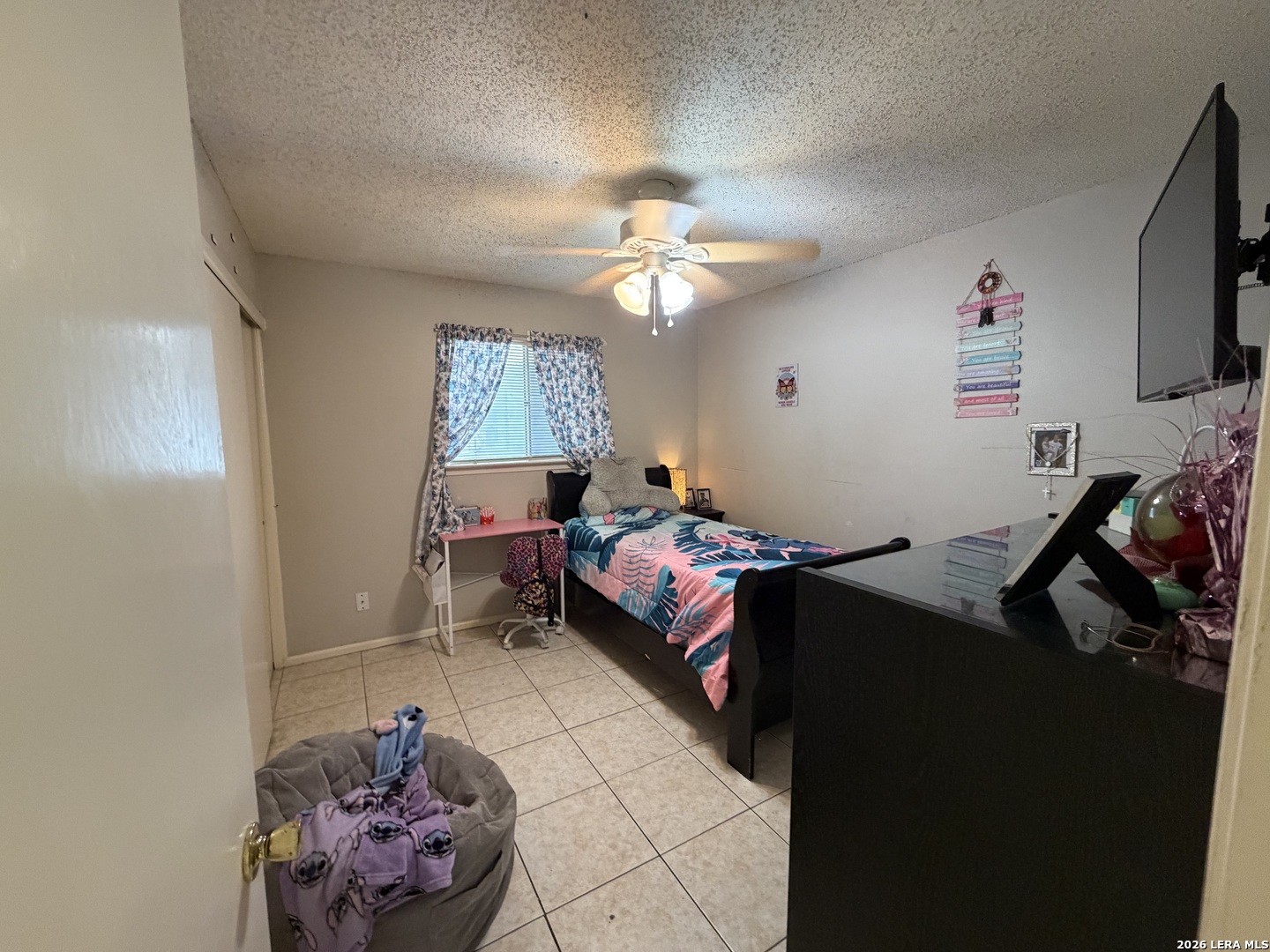 5014 Binz-Engleman Road San Antonio, TX 78219 - Photo 15 of 21 a bedroom with a bed and a chandelier