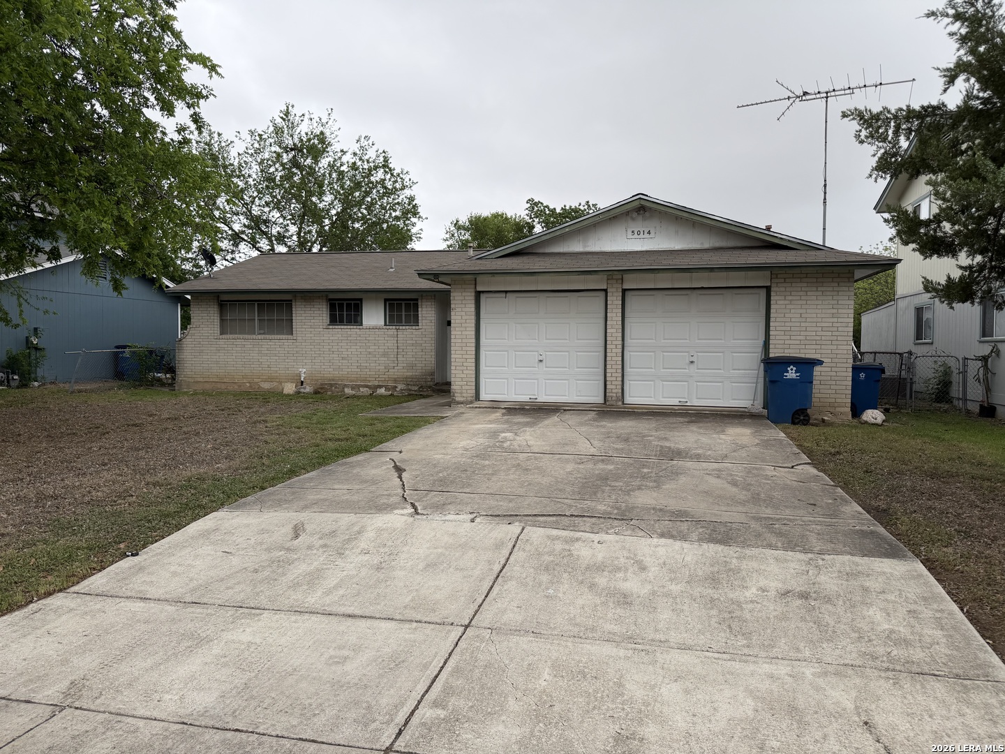 5014 Binz-Engleman Road San Antonio, TX 78219 - Photo 20 of 21 a front view of a house with a yard and garage