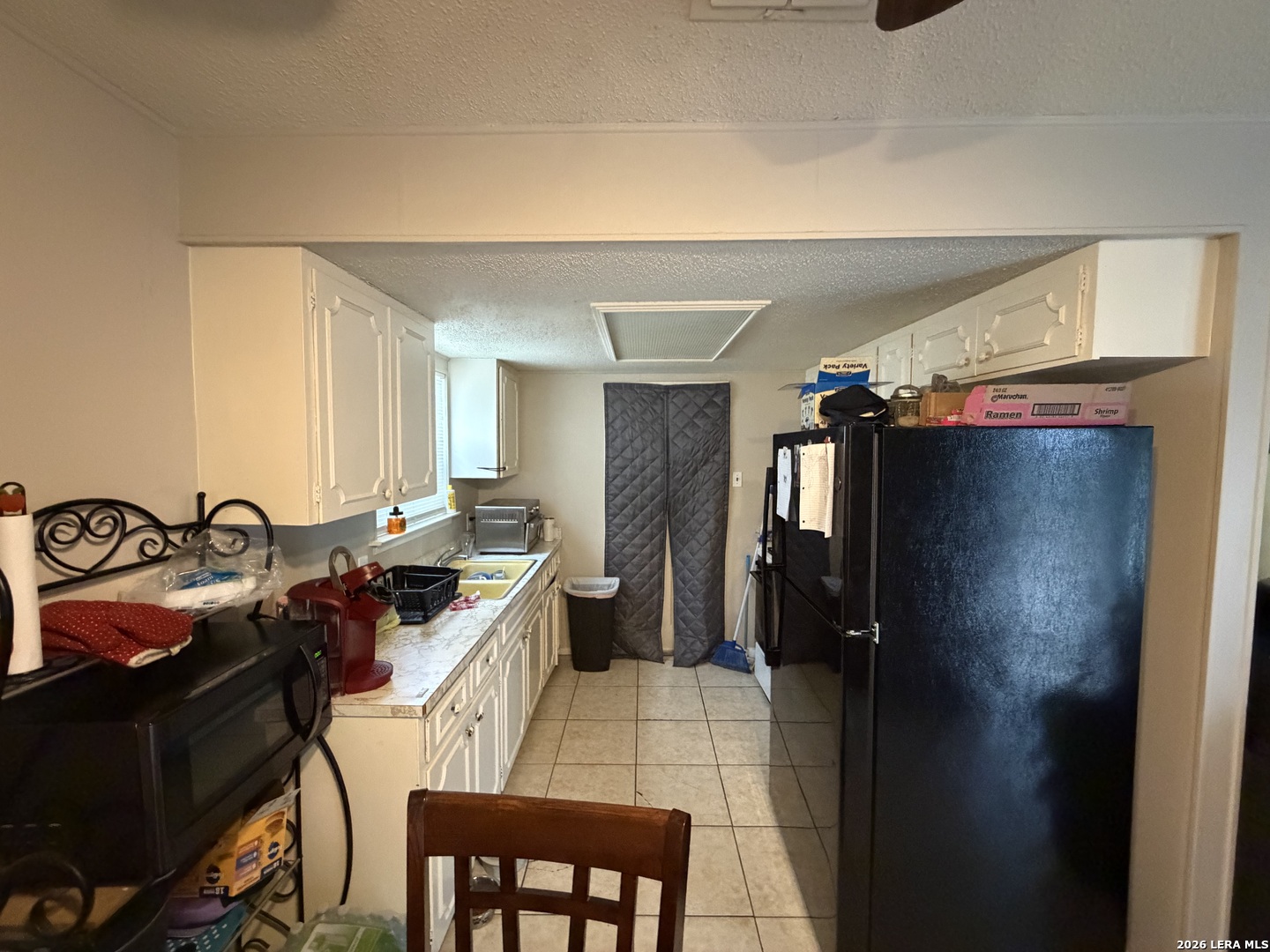 5014 Binz-Engleman Road San Antonio, TX 78219 - Photo 5 of 21 a kitchen with a sink and a refrigerator