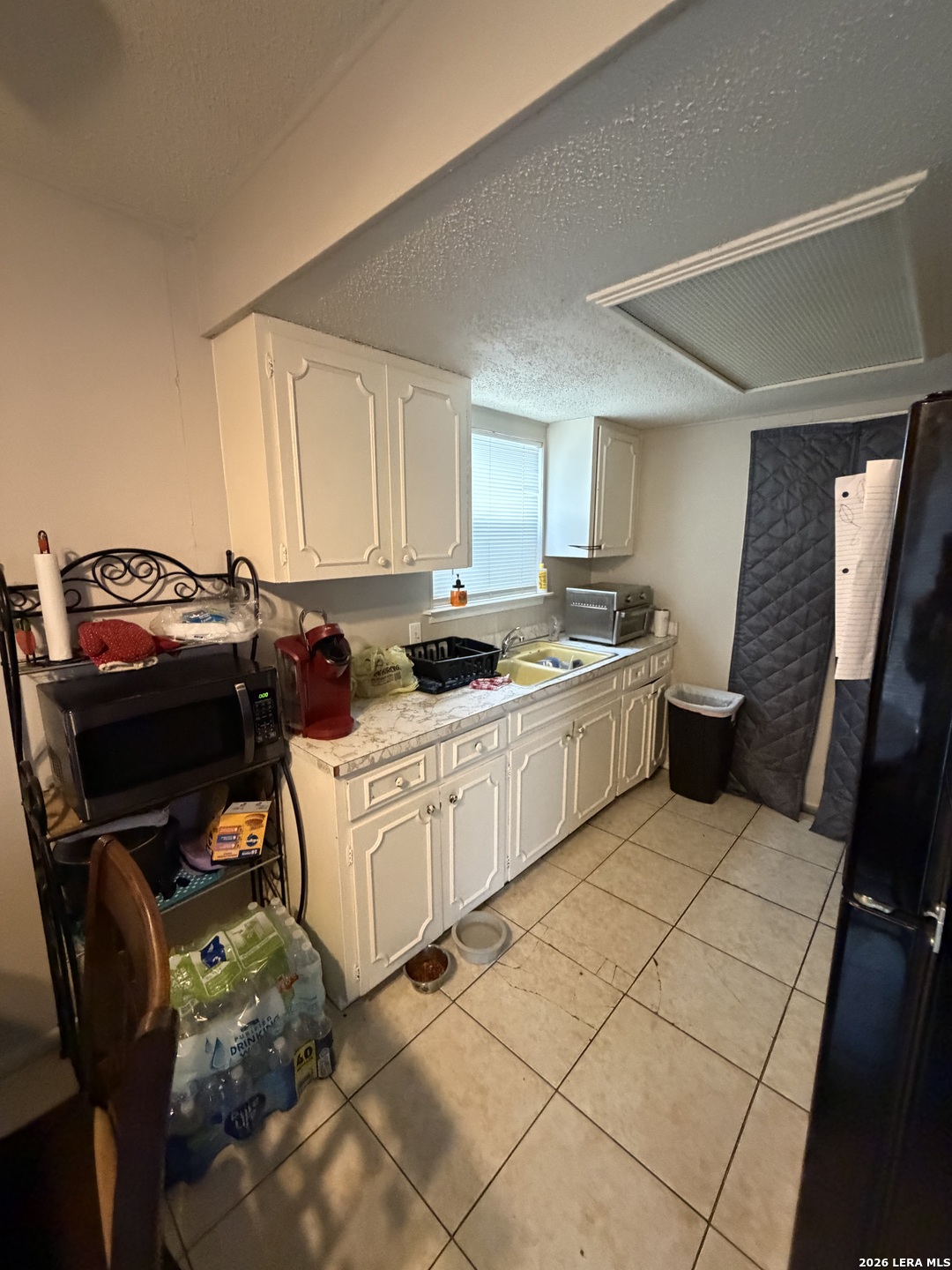 5014 Binz-Engleman Road San Antonio, TX 78219 - Photo 6 of 21 a kitchen with a stove a sink and a microwave