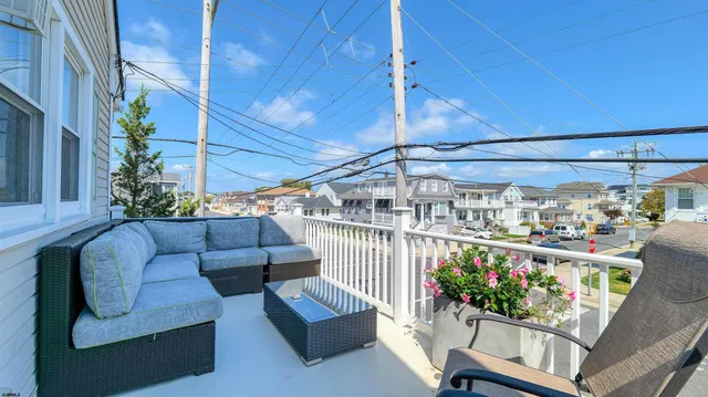a view of living room filled with furniture and flowers
