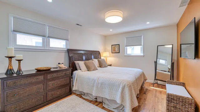 a bedroom with a bed and wooden floor