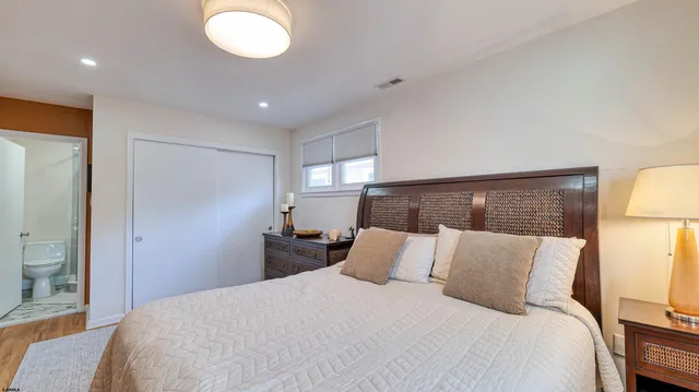 a bedroom with a bed and a lamp