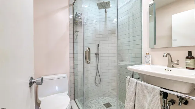 a bathroom with a sink toilet and shower