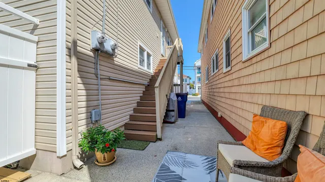 a view of a patio with chairs and potted plants