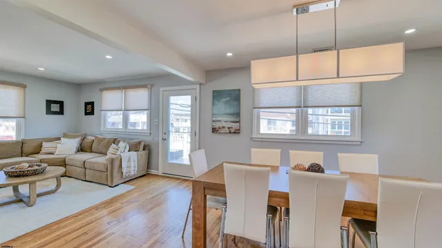 a living room with furniture a ceiling fan and a window