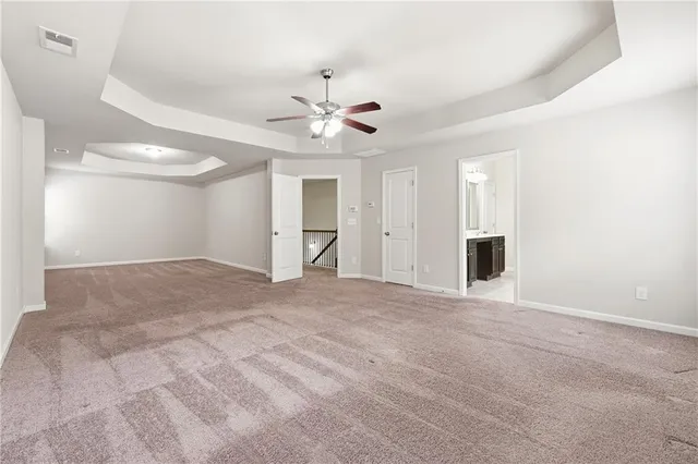 a view of an empty room with a ceiling fan