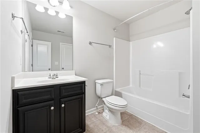 a bathroom with a toilet a sink a mirror and a bathtub