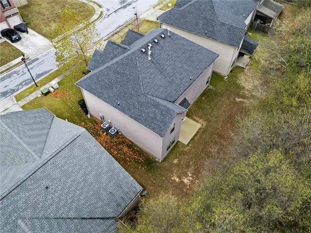 an aerial view of a house with a yard and a garage