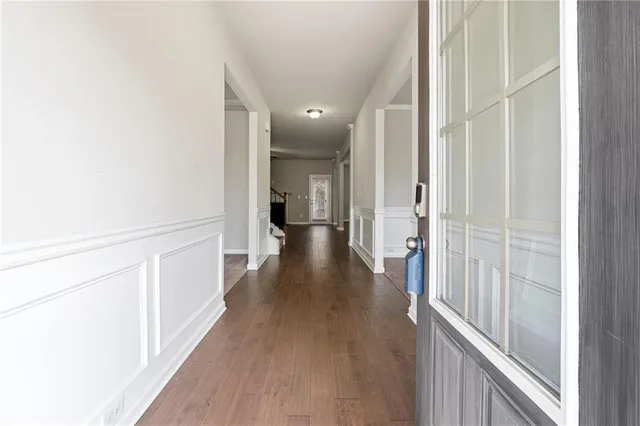 a view of a hallway with wooden floor