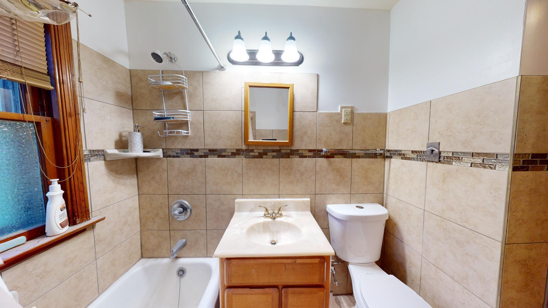 4377 Kentucky Street Gary, IN 46409 - Photo 12 of 20 a bathroom with a sink a toilet and mirror
