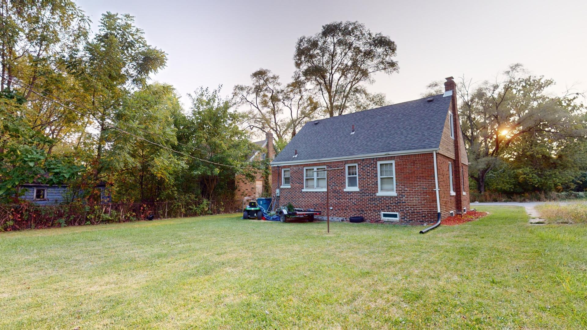 4377 Kentucky Street Gary, IN 46409 - Photo 20 of 20 a front view of a house with a yard and trees