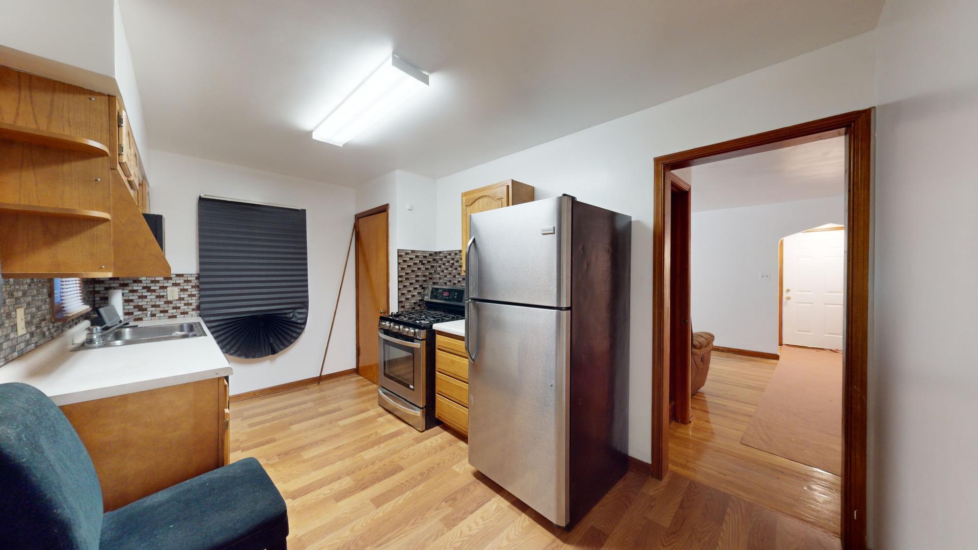 4377 Kentucky Street Gary, IN 46409 - Photo 6 of 20 a living room with a couch and a refrigerator