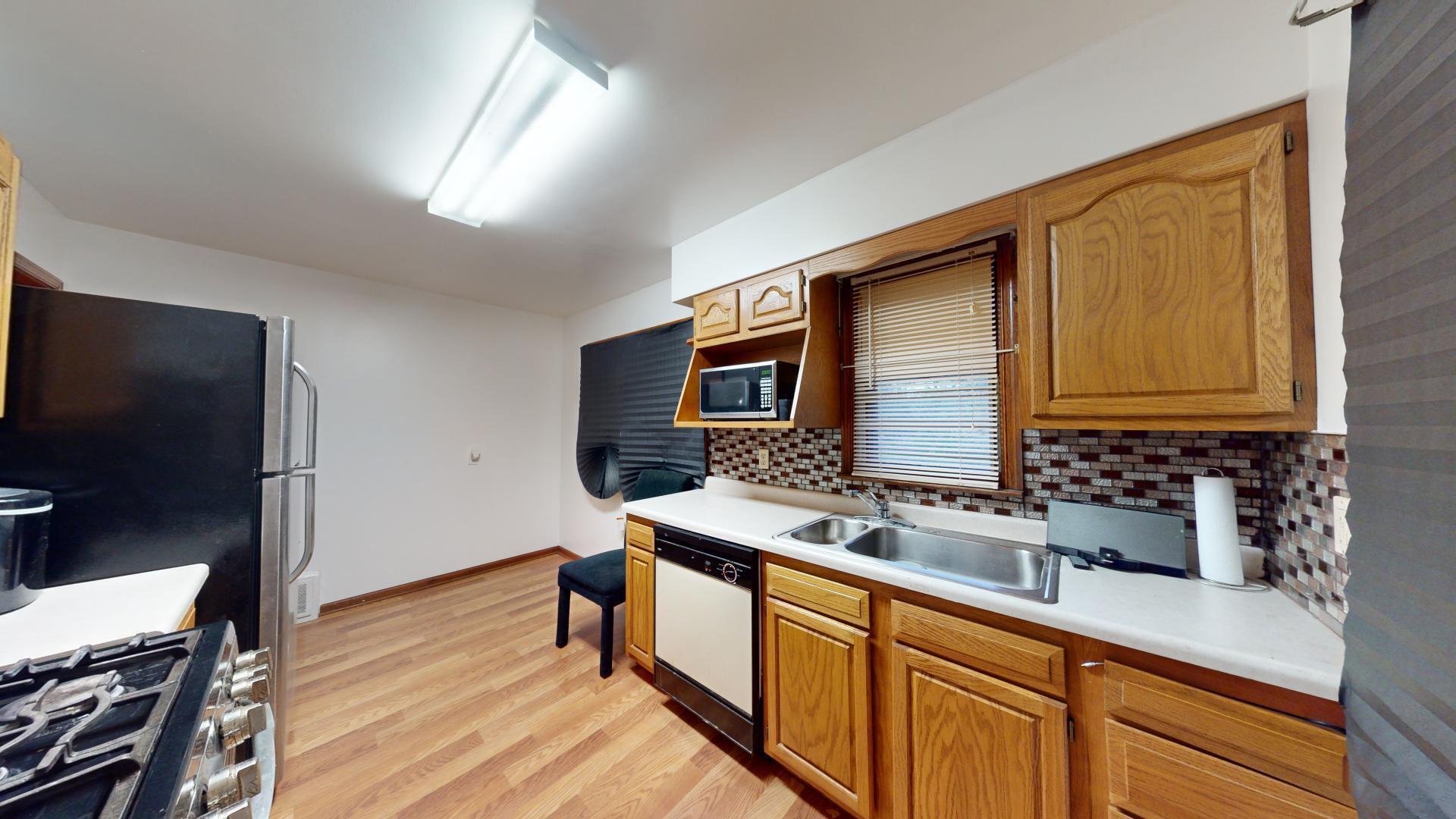 4377 Kentucky Street Gary, IN 46409 - Photo 7 of 20 a kitchen with stainless steel appliances granite countertop a sink stove and refrigerator