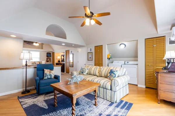 a living room with furniture a rug and a chandelier