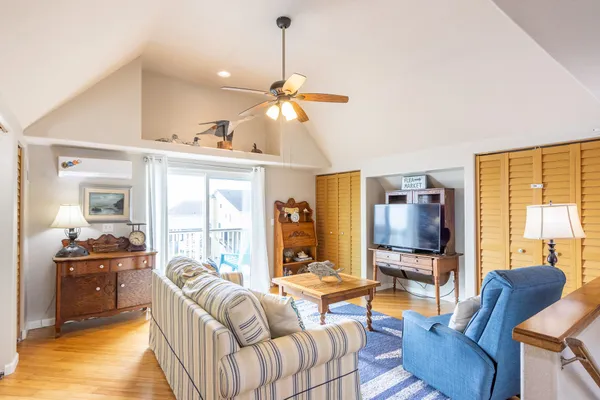 a living room with furniture fireplace and a large window