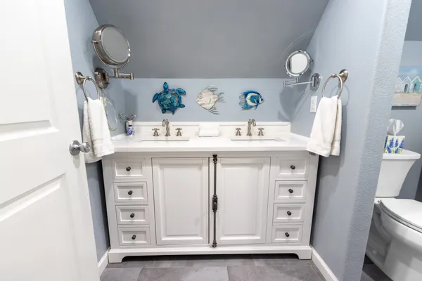 a bathroom with a sink vanity and mirror