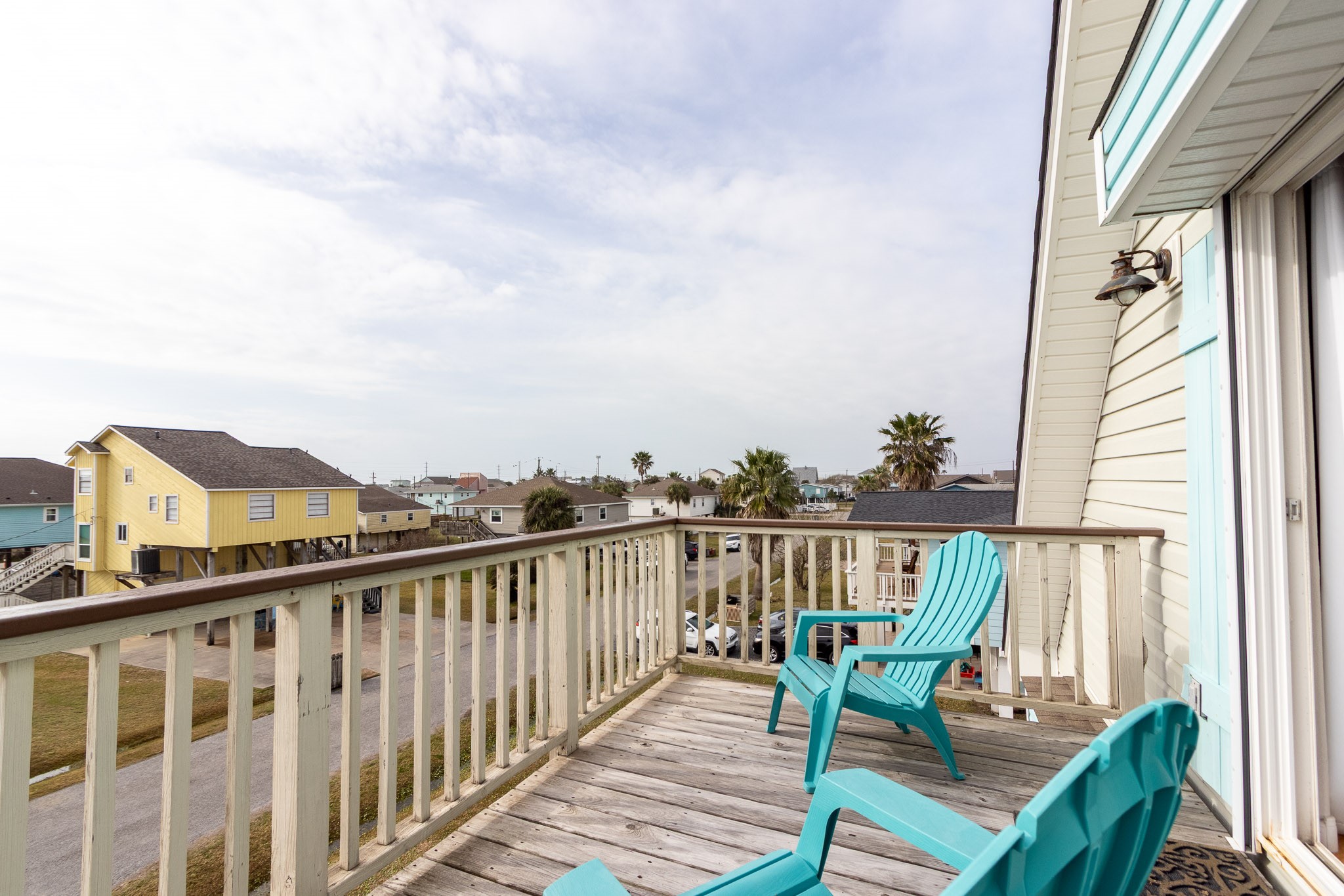 16518 Jean Lafitte Road Jamaica Beach, TX 77554 - Photo 24 of 43 a view of a balcony with wooden chairs