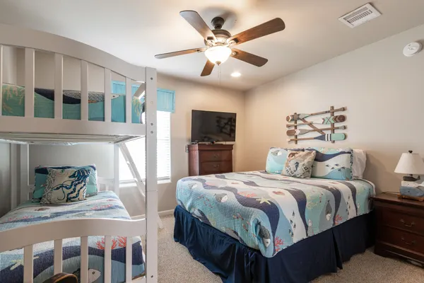 a bedroom with a large bed and a chandelier