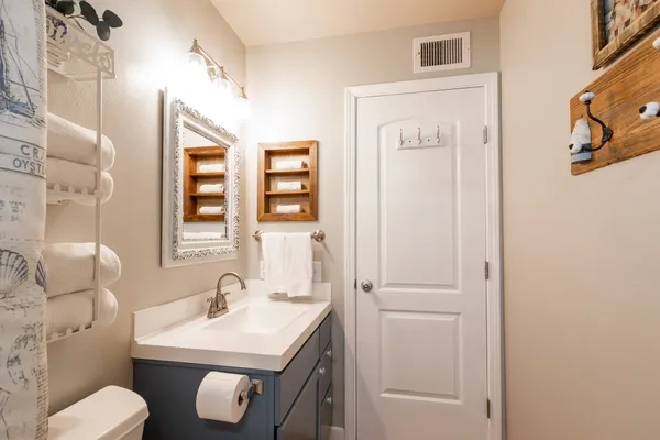 a bathroom with a sink toilet and mirror