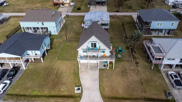 an aerial view of residential houses with outdoor space